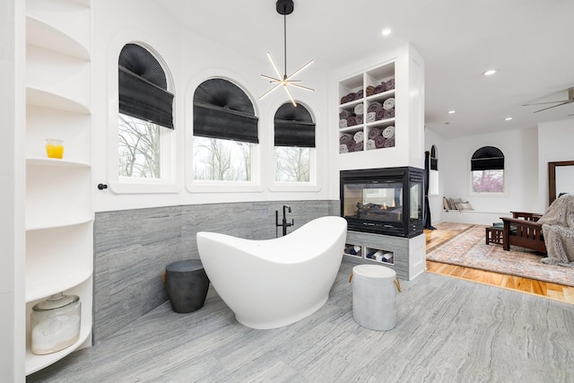 720 Valhalla Ln, Brentwood, TN 37027 - full bathroom featuring built in features, a soaking tub, recessed lighting, a multi sided fireplace, and a ceiling fan