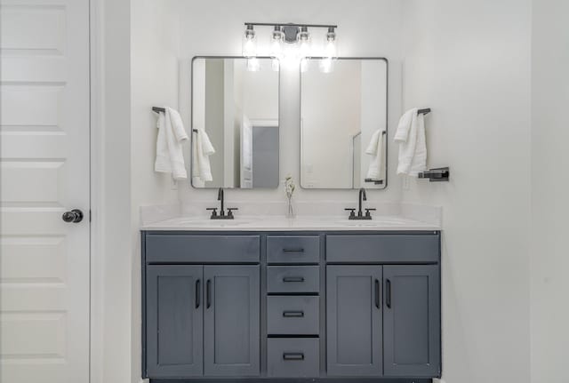 bathroom featuring double vanity and a sink