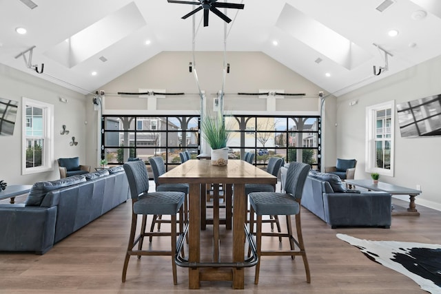 dining space featuring a skylight, a ceiling fan, and a wealth of natural light