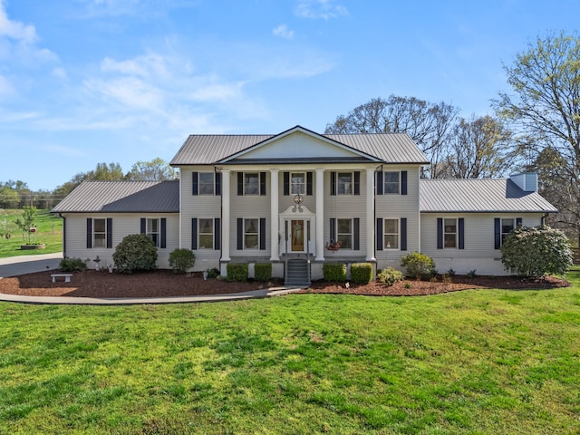 1737 Bratton Ln, Williamsport, TN 38487 - neoclassical home with metal roof, cooling unit, and a front lawn
