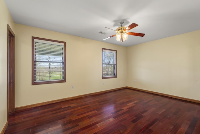 1737 Bratton Ln, Williamsport, TN 38487 - spare room featuring a ceiling fan, visible vents, baseboards, and dark wood finished floors