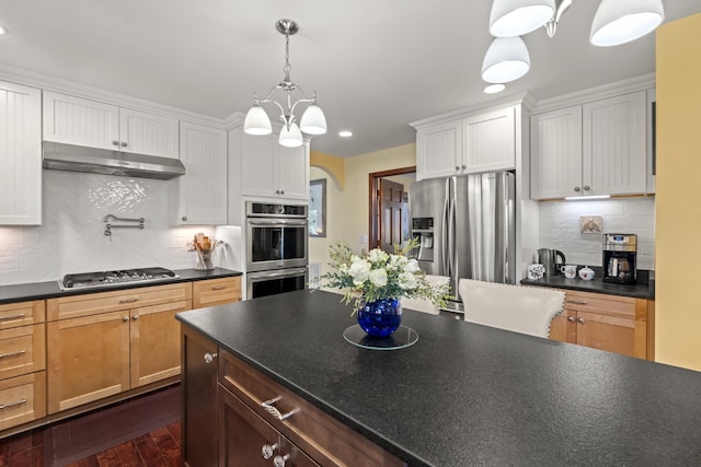 1737 Bratton Ln, Williamsport, TN 38487 - kitchen with dark countertops, a chandelier, stainless steel appliances, and under cabinet range hood