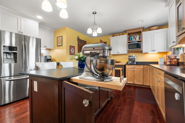 1737 Bratton Ln, Williamsport, TN 38487 - kitchen with a chandelier, dark countertops, dark wood-style flooring, and appliances with stainless steel finishes