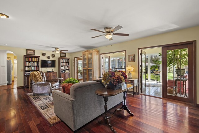 1737 Bratton Ln, Williamsport, TN 38487 - living area featuring a ceiling fan, arched walkways, wood finished floors, and baseboards