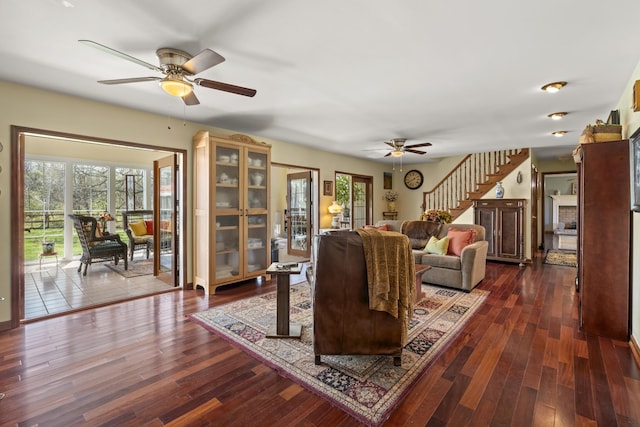 1737 Bratton Ln, Williamsport, TN 38487 - living room with a brick fireplace, ceiling fan, dark wood-style floors, and stairs