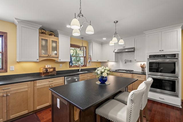 1737 Bratton Ln, Williamsport, TN 38487 - kitchen featuring a sink, under cabinet range hood, dark countertops, appliances with stainless steel finishes, and dark wood finished floors
