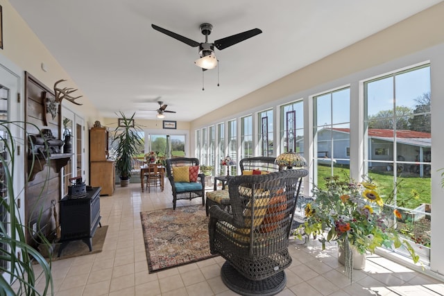 1737 Bratton Ln, Williamsport, TN 38487 - sunroom / solarium featuring a wood stove, ceiling fan, and an outdoor hangout area