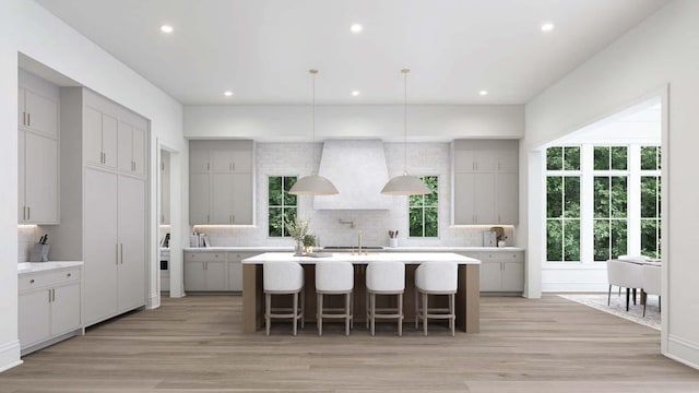 544 Bonaire Ln, Franklin, TN 37064 - kitchen with custom exhaust hood, tasteful backsplash, a kitchen island with sink, and recessed lighting