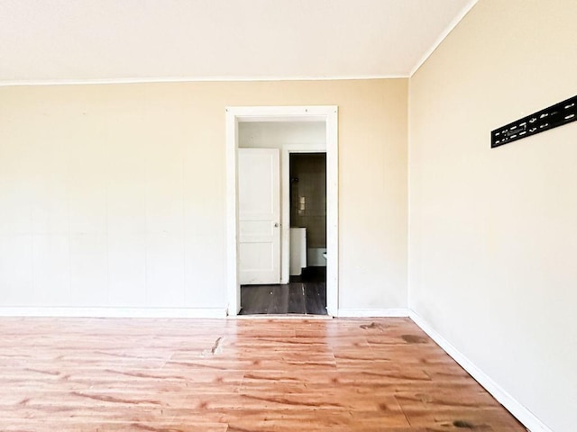unfurnished room with baseboards, wood finished floors, and ornamental molding