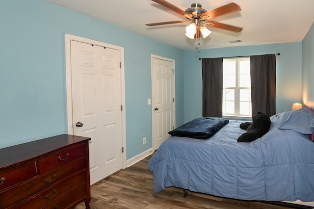 602 Bradburn Village Cir, Antioch, TN 37013 - bedroom featuring baseboards, dark wood-style floors, visible vents, and ceiling fan