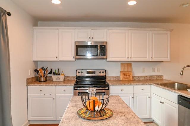 602 Bradburn Village Cir, Antioch, TN 37013 - kitchen with white cabinets, a sink, and appliances with stainless steel finishes