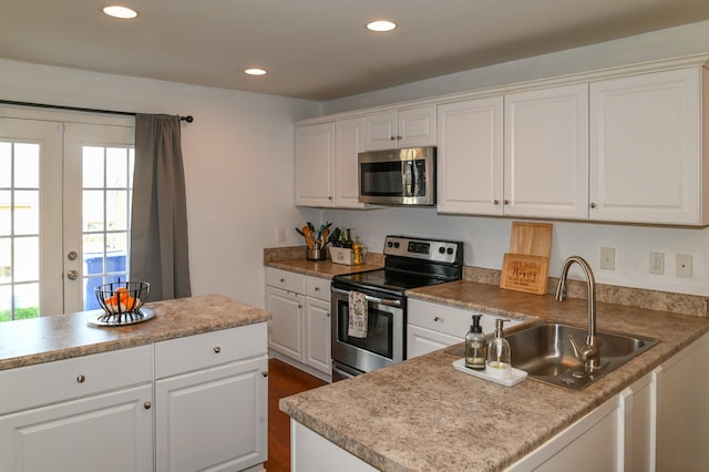 602 Bradburn Village Cir, Antioch, TN 37013 - kitchen with white cabinets, a sink, stainless steel appliances, and recessed lighting