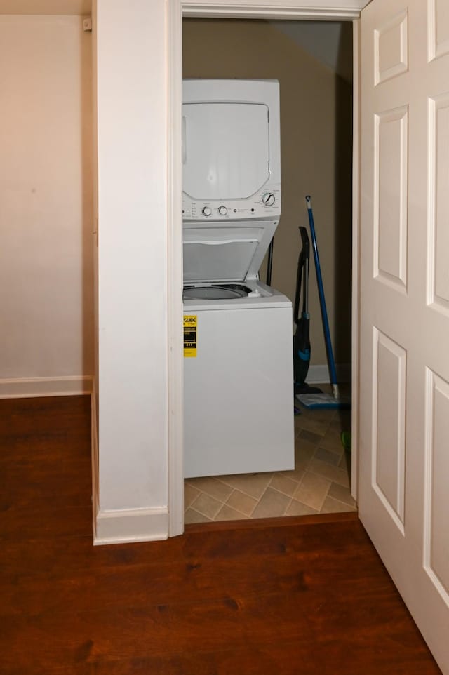 602 Bradburn Village Cir, Antioch, TN 37013 - laundry area featuring baseboards, stacked washer / drying machine, laundry area, and wood finished floors