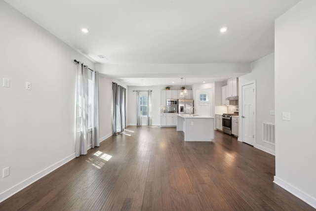 unfurnished living room featuring recessed lighting, dark wood-style flooring, baseboards, and visible vents