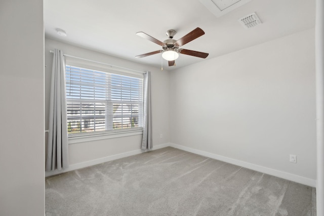 empty room with visible vents, ceiling fan, carpet flooring, and baseboards