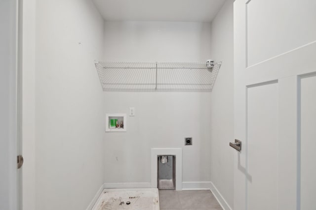 washroom featuring electric dryer hookup, baseboards, light tile patterned floors, laundry area, and hookup for a washing machine