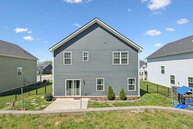 back of property with a patio area, a fenced backyard, and a lawn