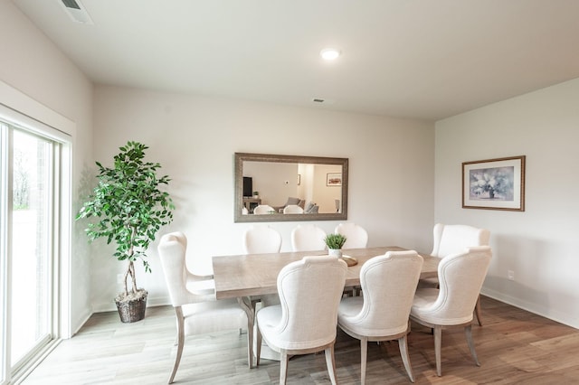 dining room featuring baseboards, visible vents, recessed lighting, and light wood finished floors