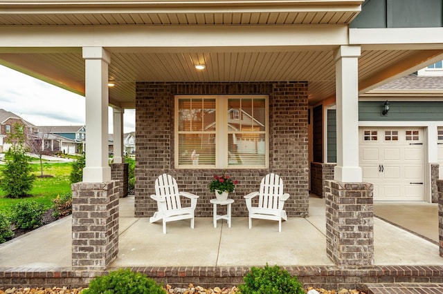 view of patio featuring a porch and a garage