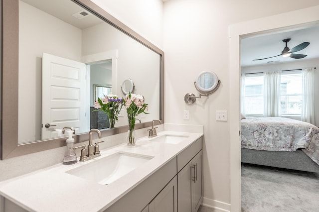 ensuite bathroom with double vanity, a sink, connected bathroom, and visible vents