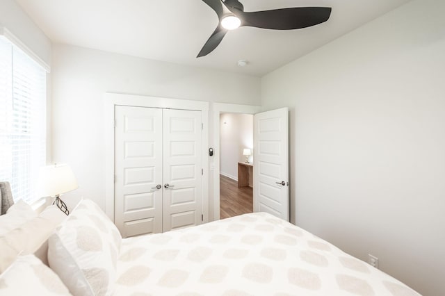 bedroom with a ceiling fan, a closet, and wood finished floors