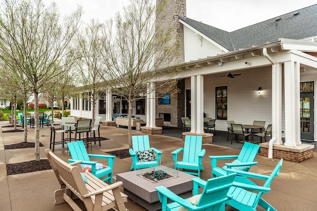 view of patio / terrace with a ceiling fan and a fire pit