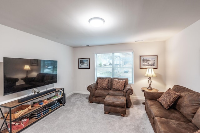 carpeted living area with baseboards and visible vents