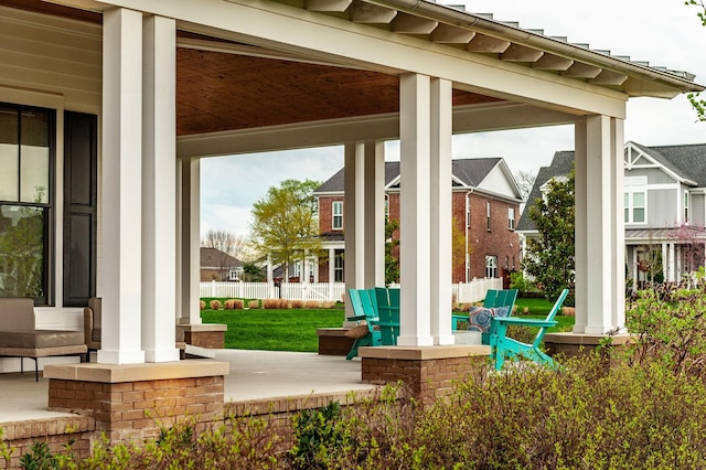 view of patio with a porch and fence