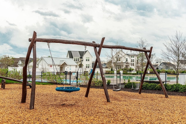 community jungle gym featuring a residential view and fence