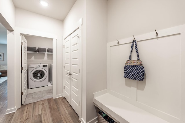 mudroom with independent washer and dryer and wood finished floors