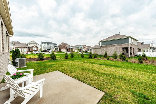 view of yard featuring central AC unit and a residential view