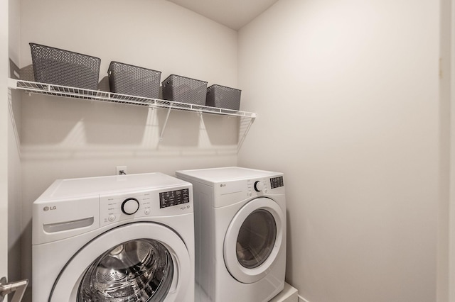 clothes washing area featuring washing machine and dryer and laundry area