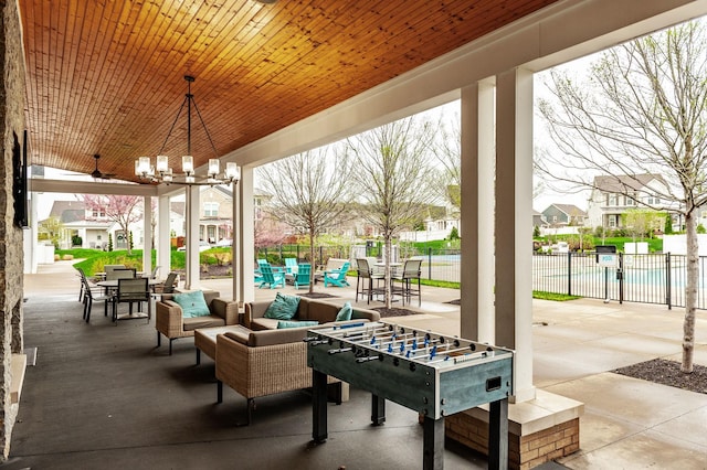 view of patio featuring outdoor lounge area, fence, and a residential view