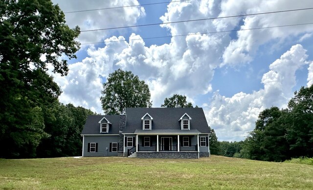 718 Darrell Rye Rd, Erin, TN 37061 - new england style home with covered porch and a front lawn