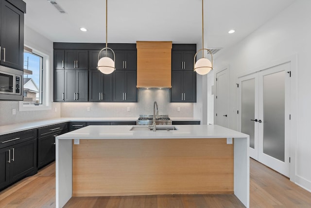 807 32nd Ave N Unit A, Nashville, TN 37209 - kitchen featuring light countertops, tasteful backsplash, a sink, and stainless steel microwave