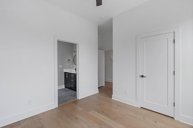 807 32nd Ave N Unit A, Nashville, TN 37209 - unfurnished bedroom with baseboards, ensuite bathroom, a sink, and light wood finished floors