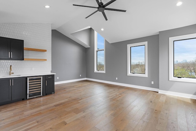 807 32nd Ave N Unit A, Nashville, TN 37209 - unfurnished living room with plenty of natural light, a sink, beverage cooler, ceiling fan, and indoor wet bar