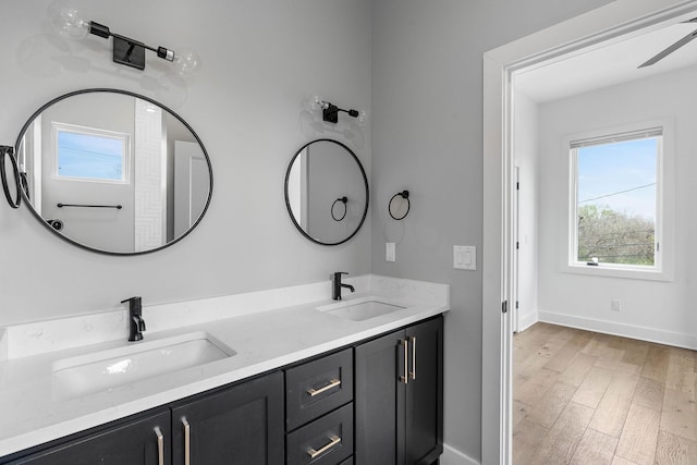 807 32nd Ave N Unit A, Nashville, TN 37209 - full bathroom with baseboards, double vanity, a sink, and wood finished floors