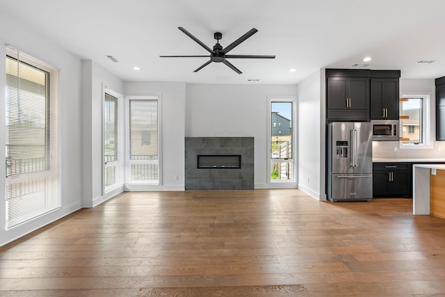 807 32nd Ave N Unit A, Nashville, TN 37209 - unfurnished living room featuring a ceiling fan, light wood-style flooring, a fireplace, and visible vents