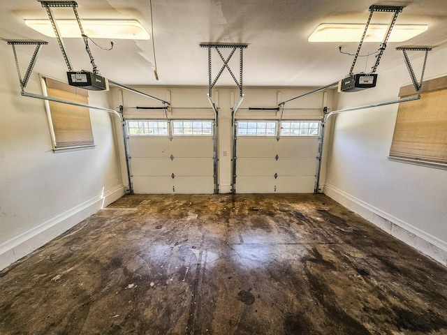 garage with baseboards and a garage door opener