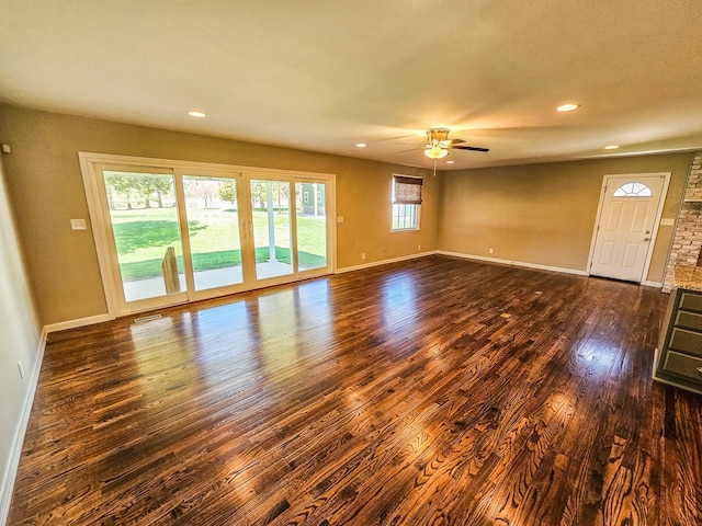 unfurnished living room with dark wood-style floors, recessed lighting, baseboards, and a ceiling fan