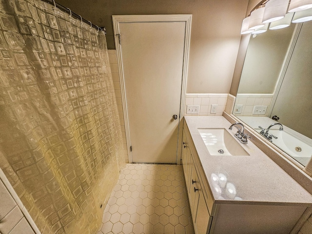 full bath featuring tile patterned floors, vanity, and curtained shower