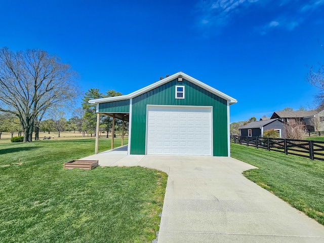 detached garage with driveway and fence