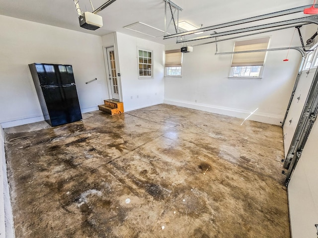 garage with baseboards and a garage door opener
