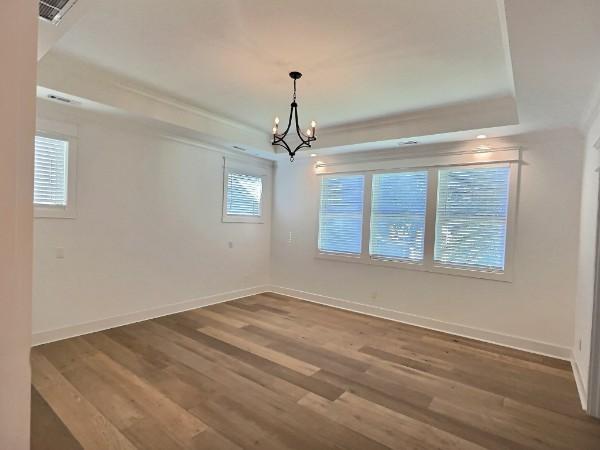 1412 Woodmont Blvd, Nashville, TN 37215 - unfurnished dining area featuring wood finished floors, a chandelier, and baseboards