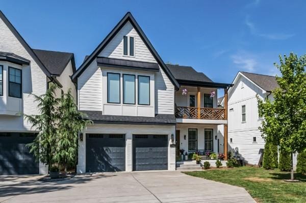 1412 Woodmont Blvd, Nashville, TN 37215 - view of front of house with a garage, a balcony, driveway, and a front yard
