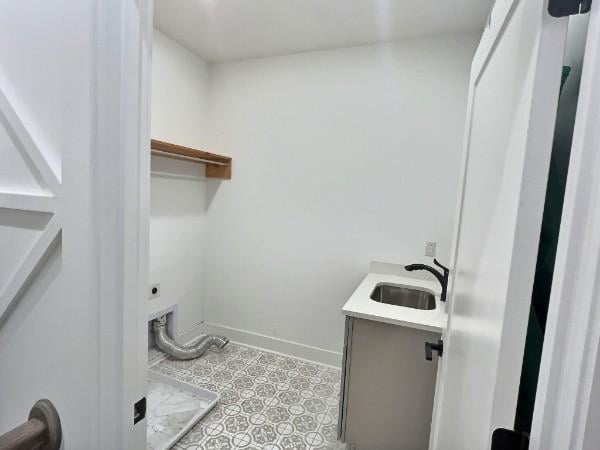1412 Woodmont Blvd, Nashville, TN 37215 - clothes washing area featuring light floors, a sink, laundry area, and baseboards