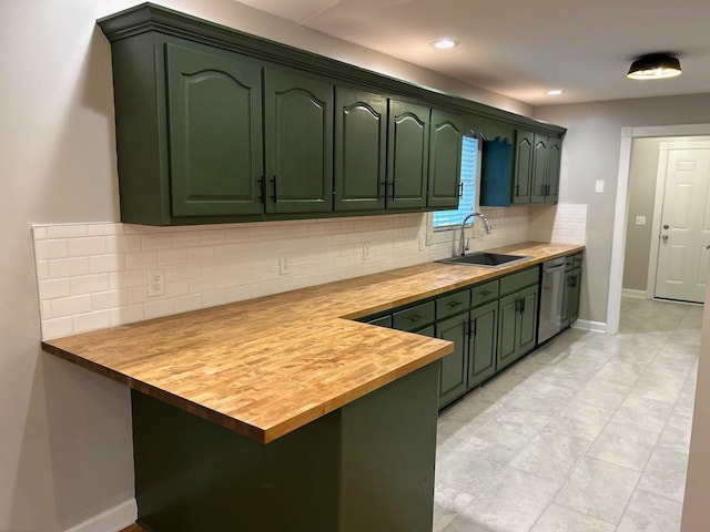 kitchen featuring butcher block countertops, stainless steel dishwasher, backsplash, a sink, and green cabinetry