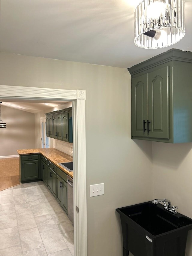 kitchen featuring light countertops, a sink, and a peninsula