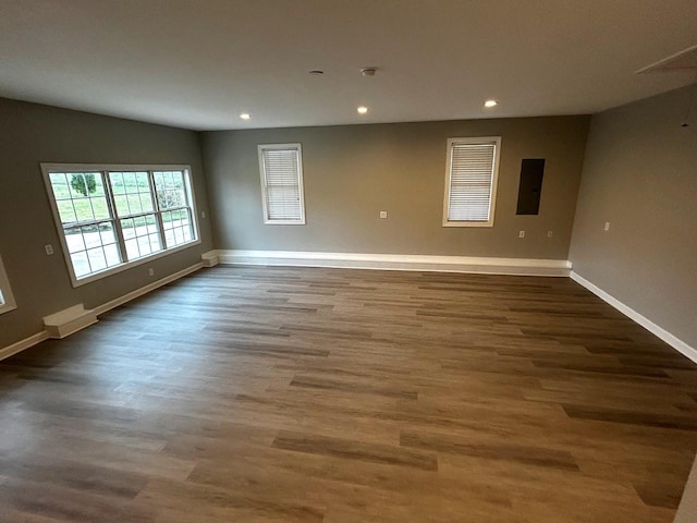 empty room with baseboards, recessed lighting, and dark wood-type flooring